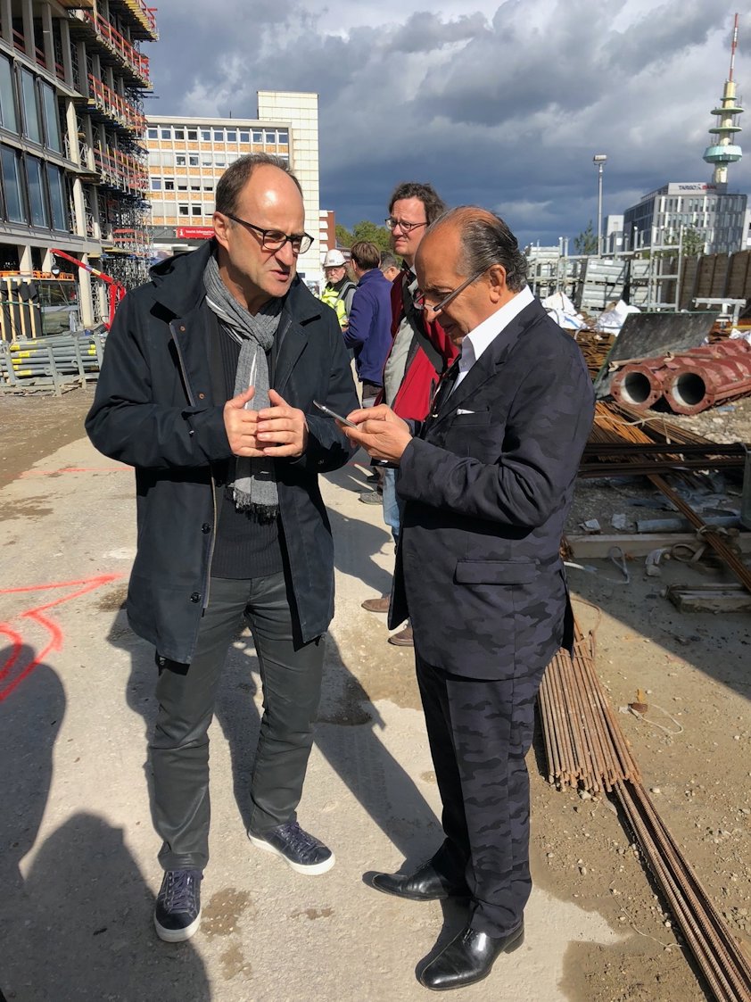 a group of men standing on a train track