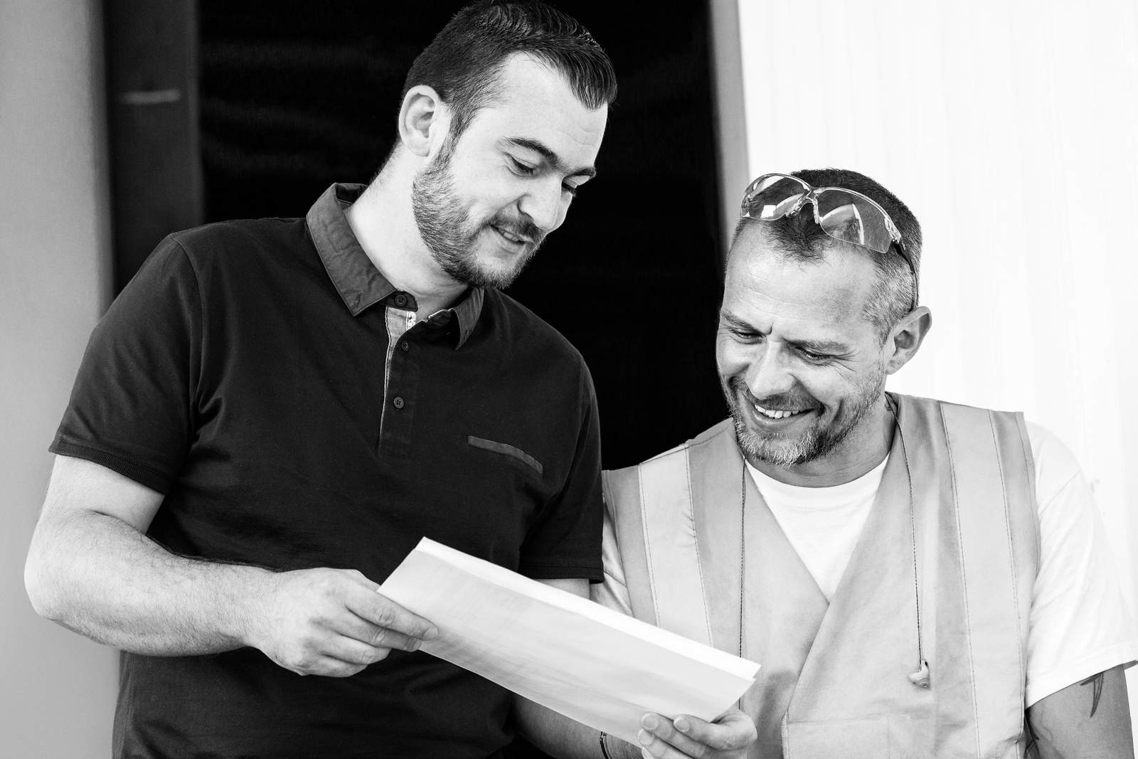 two men looking at a paper