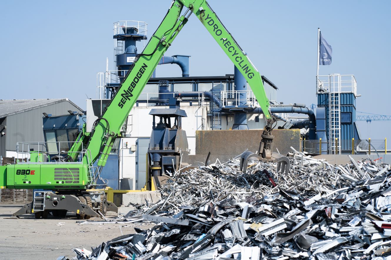 a crane lifting a pile of garbage