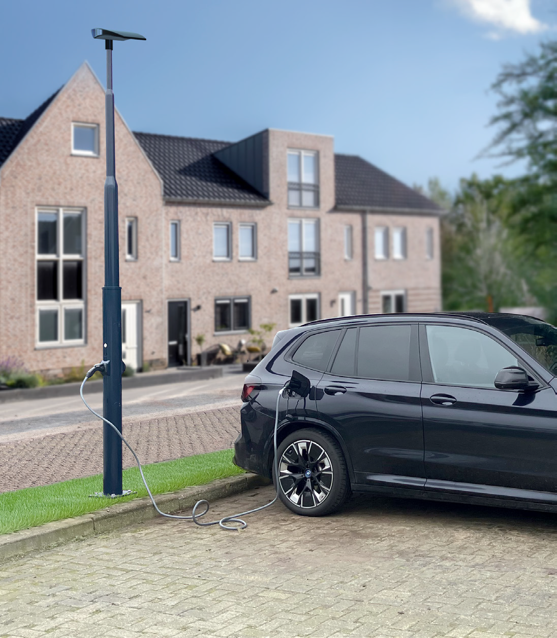 An electric car charging at an E-charge pole