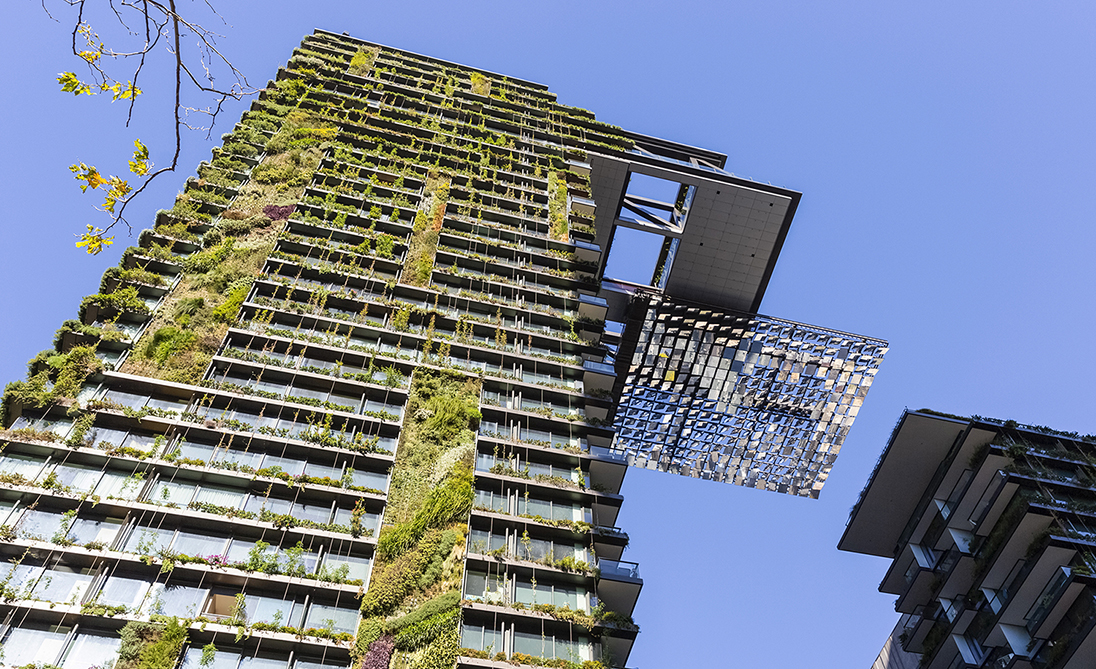 Low angle view of apartment building with vertical garden and heliostat