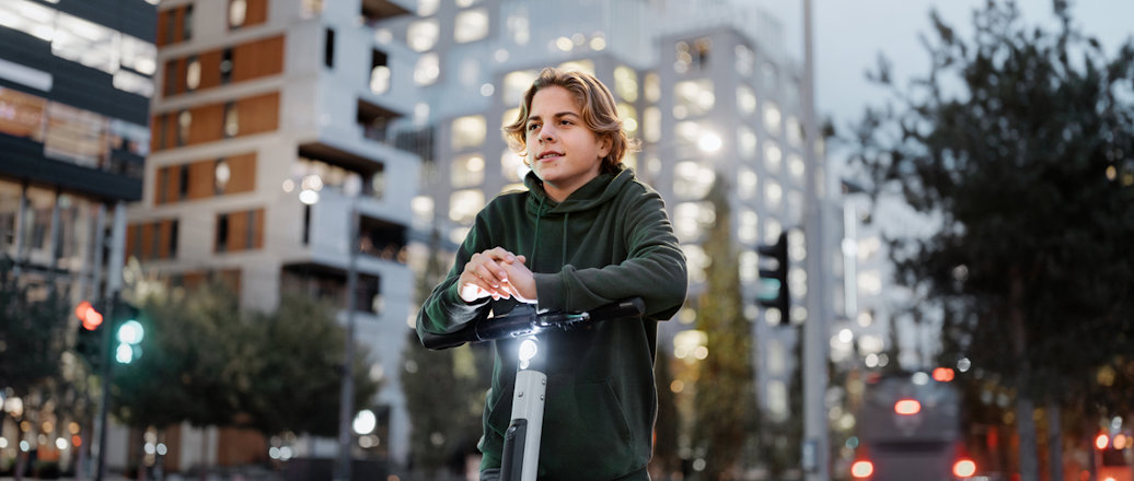 Young guy on a scooter in the city