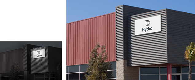 facade signage illuminated from above at night, in daylight without illumination