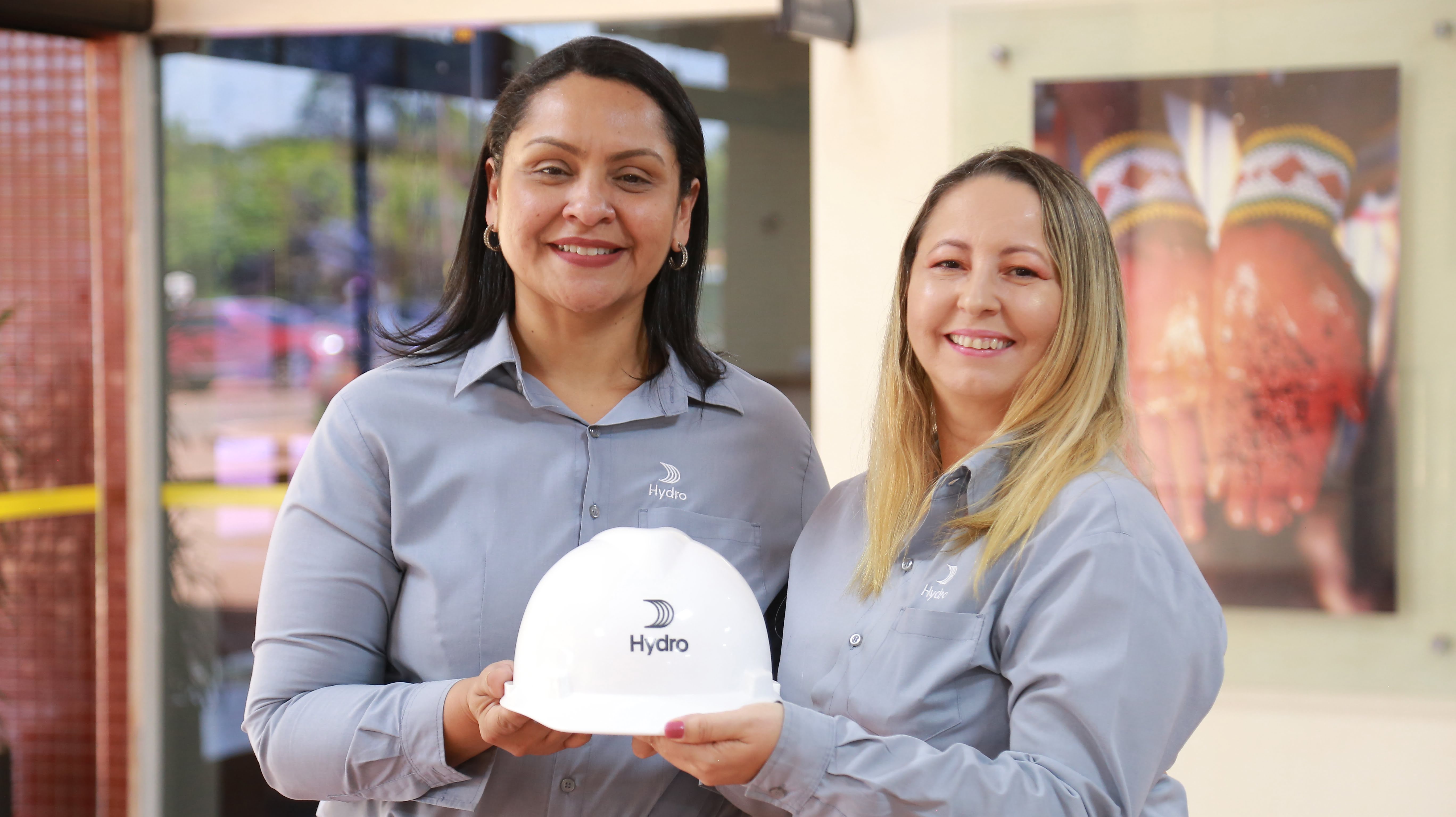 a couple of women holding a white box