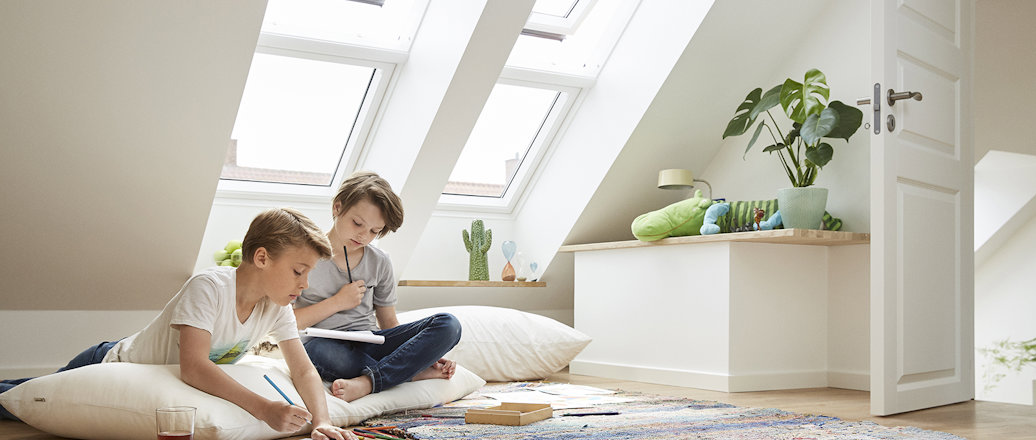 a person and a child sitting on a rug in a room