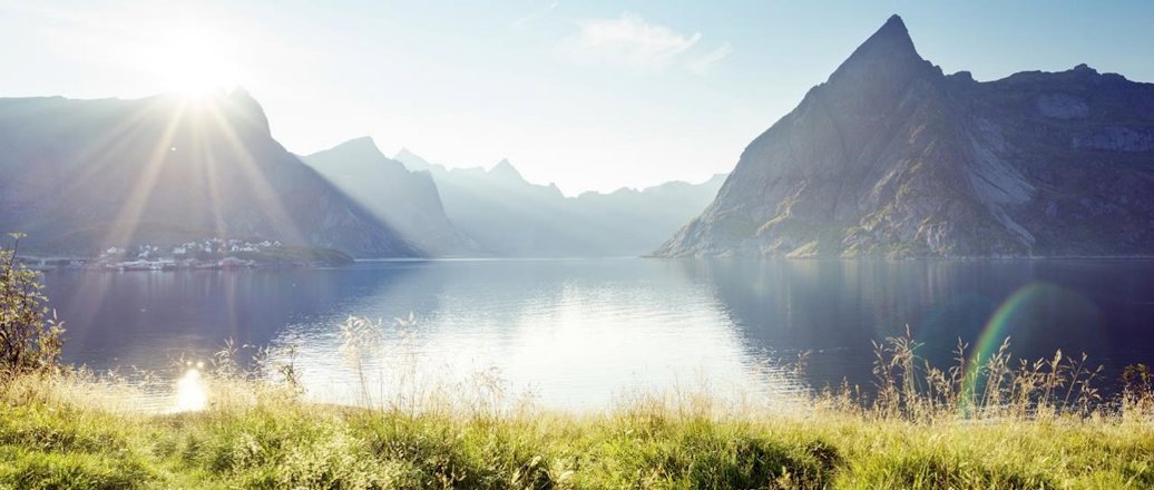 a body of water with mountains in the background with Milford Sound in the background