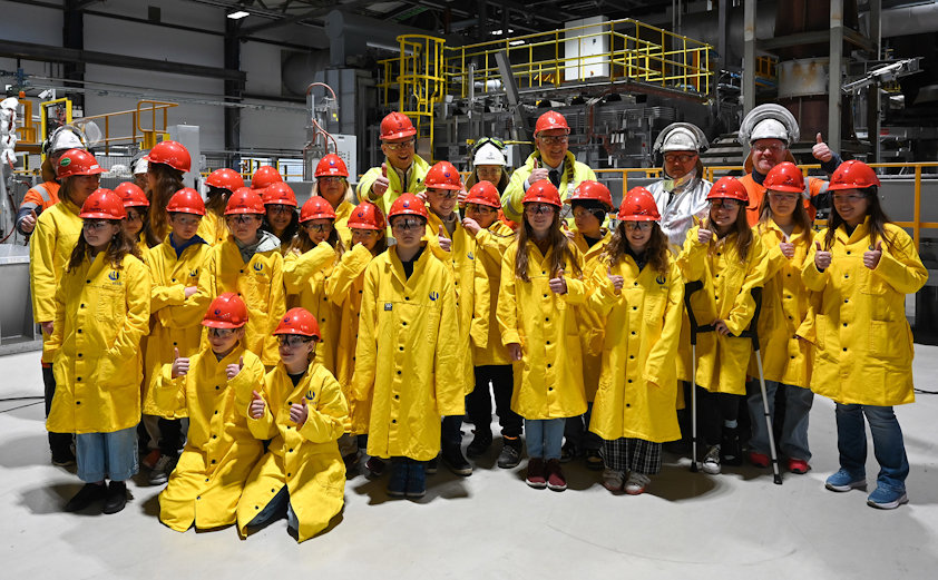 a group of people in yellow jackets