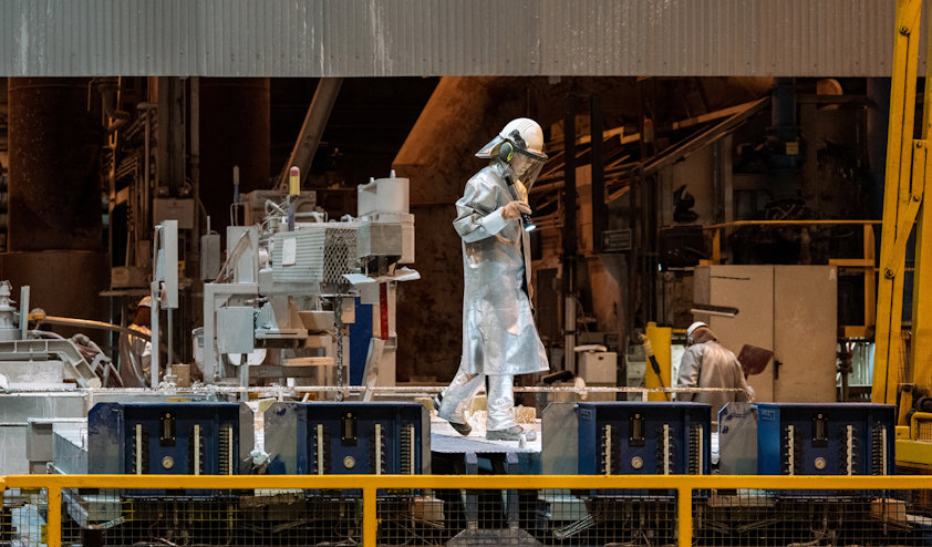 a person in a silver suit working on a machine