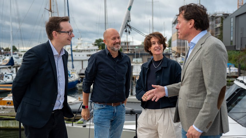 a group of people standing on a boat