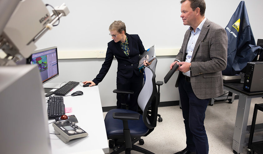 a man and a woman looking at a computer screen