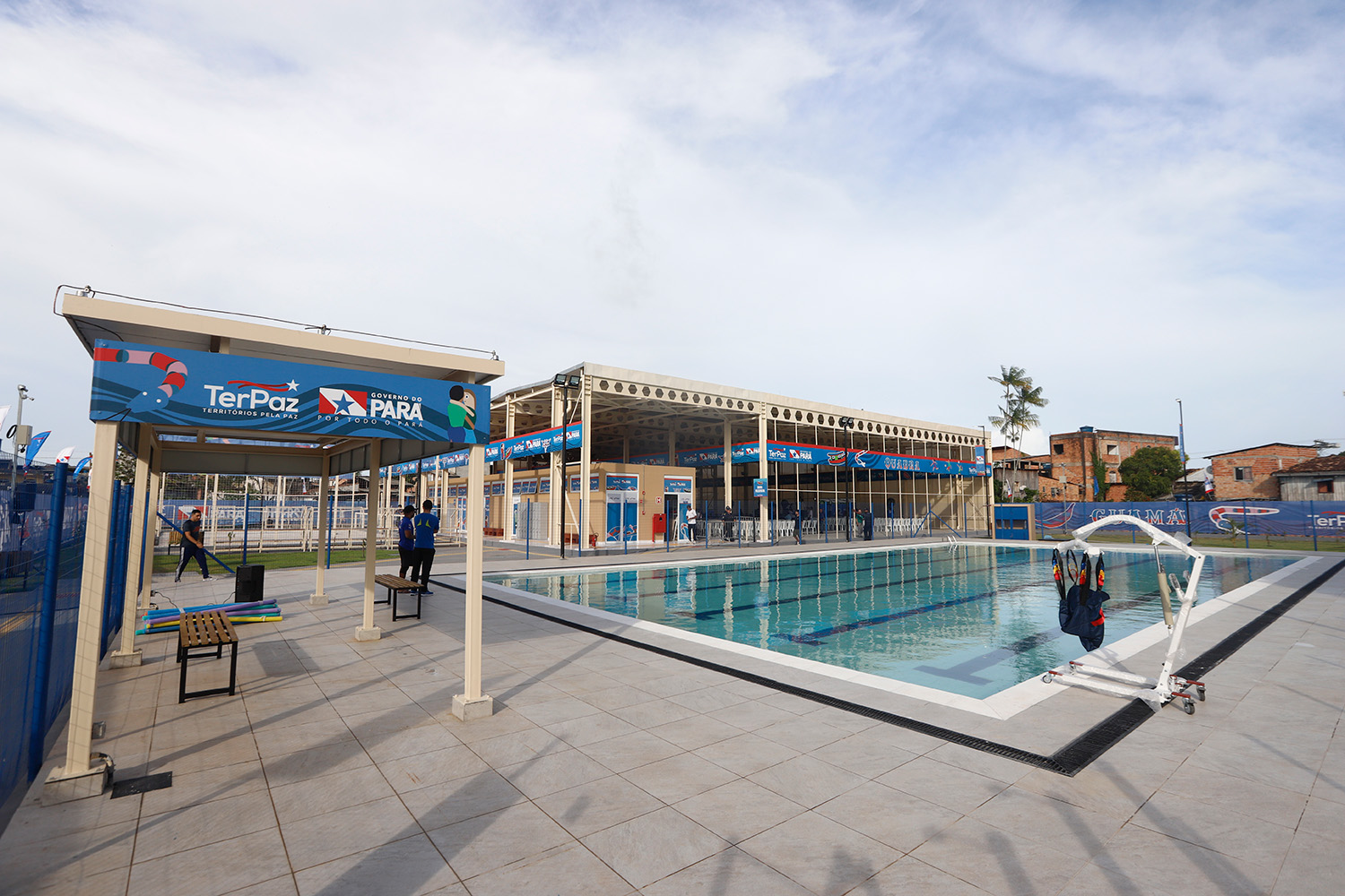 a swimming pool with people standing in front of it