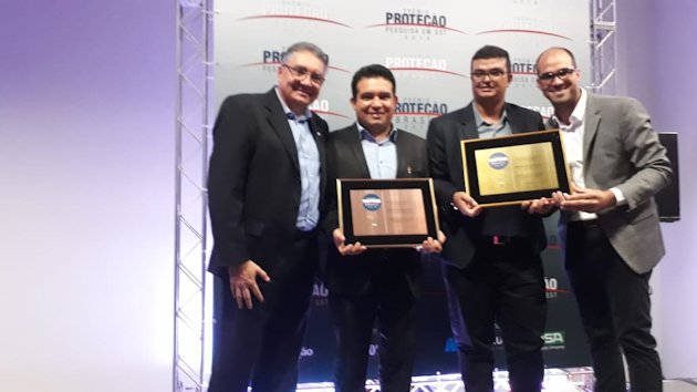 a group of men holding a plaque