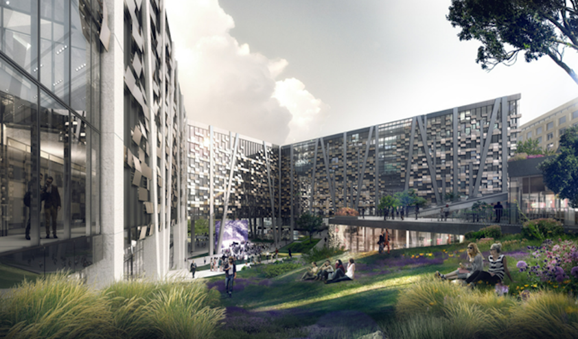 a group of people sitting on the grass in front of a building