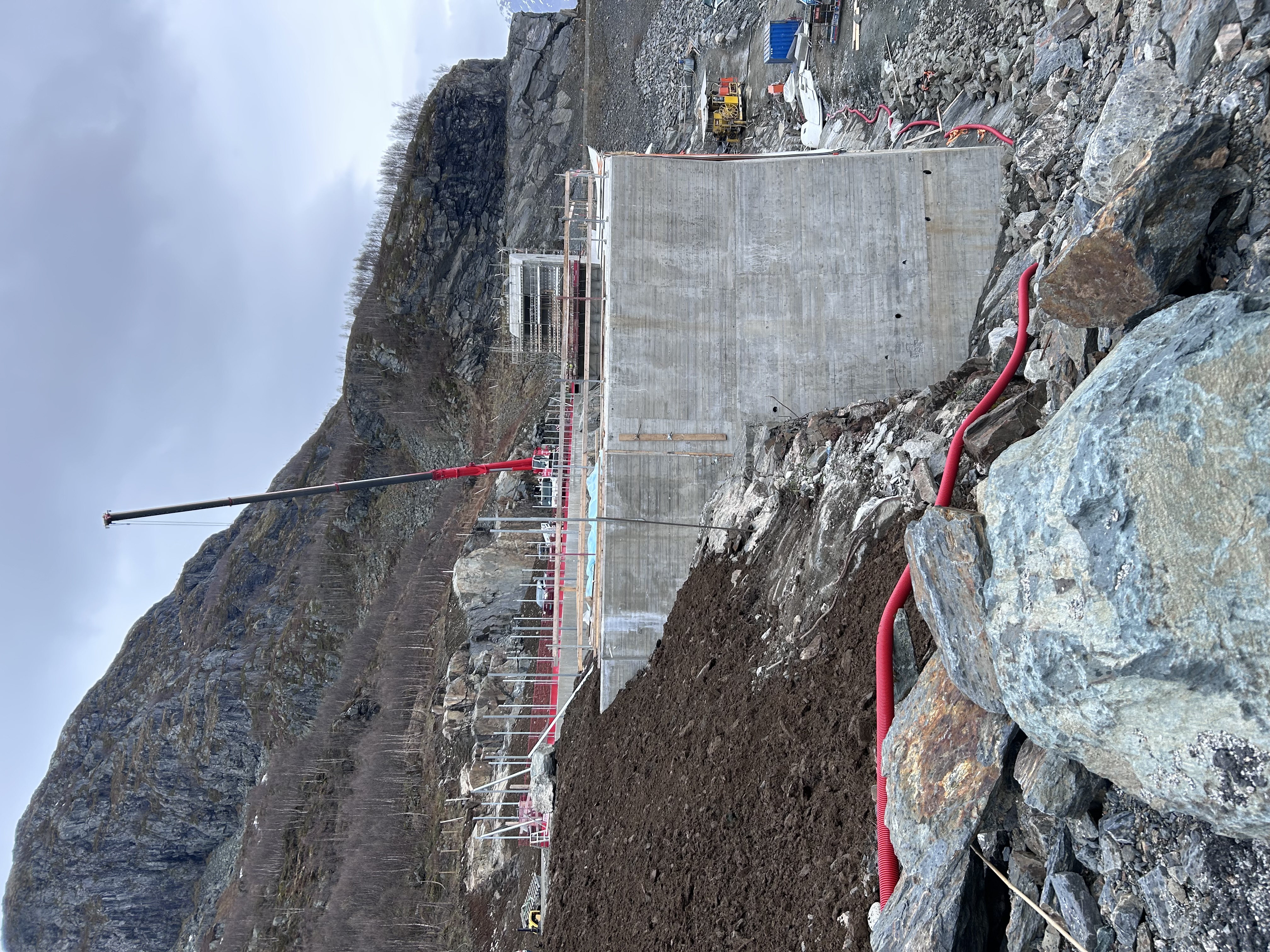 a construction site with a large hill and rocks