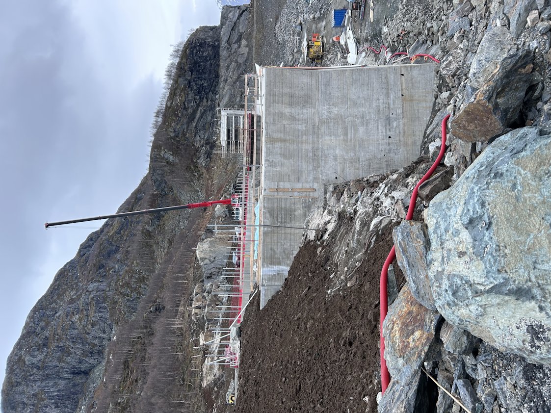 a construction site with a large hill and rocks