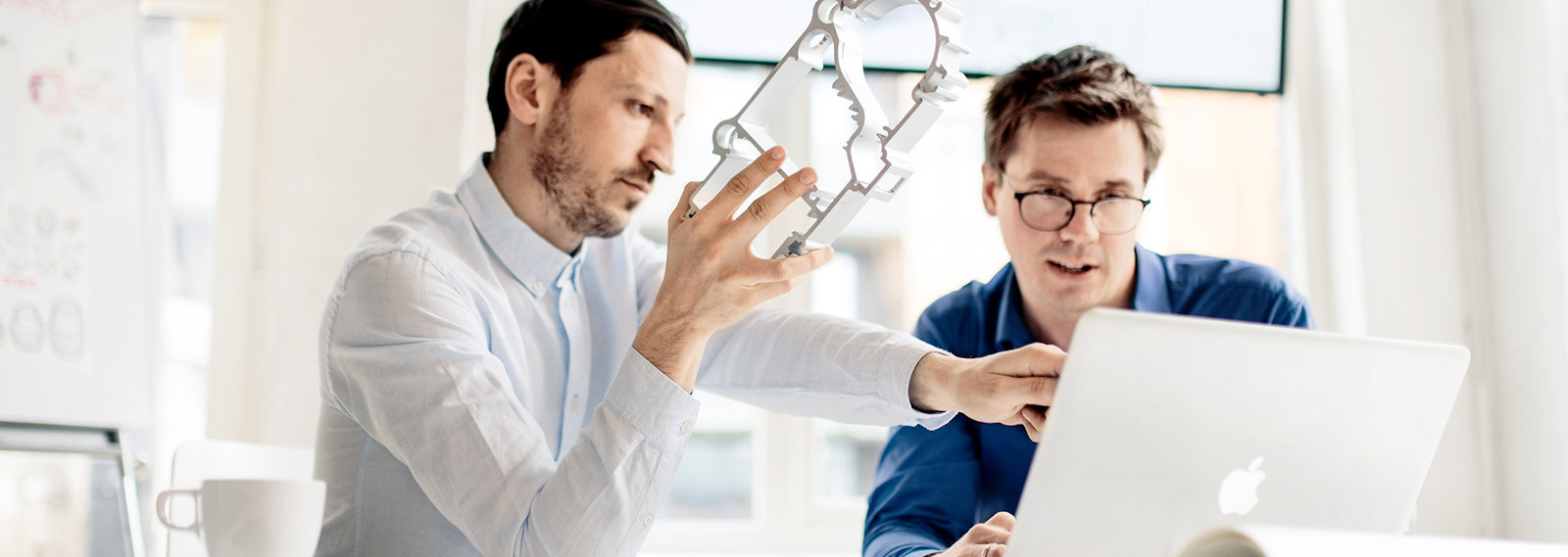 a person showing a person something on the computer