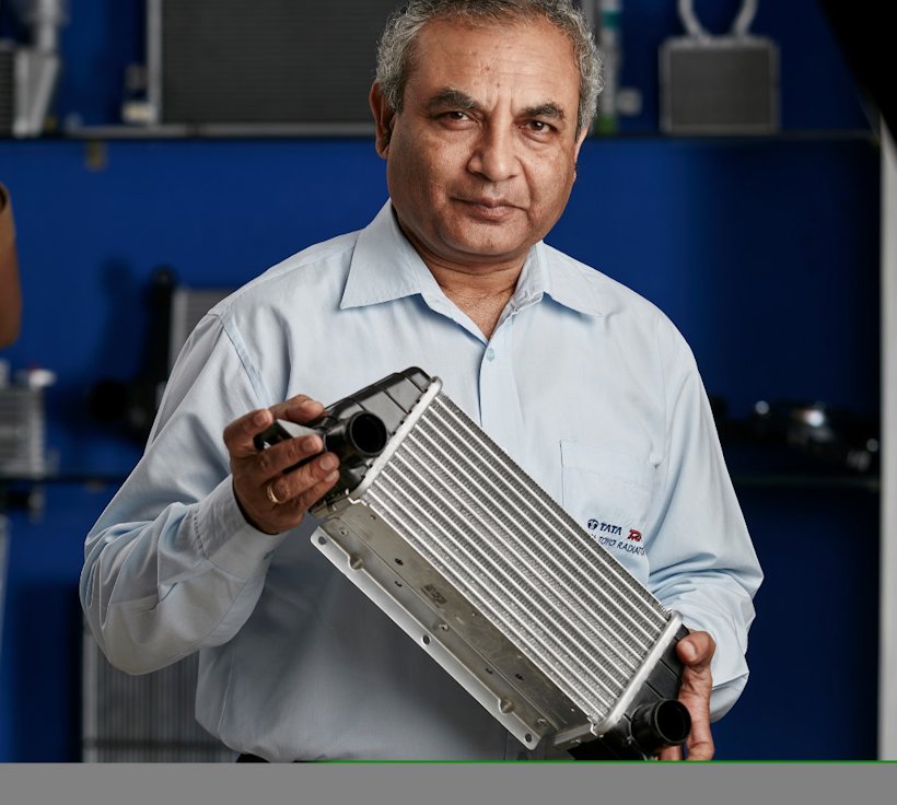 Ravi Chidambar holding a heat exchanger