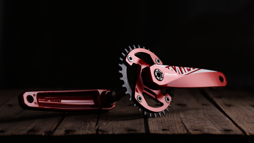 a pair of red and white roller blades on a wooden surface