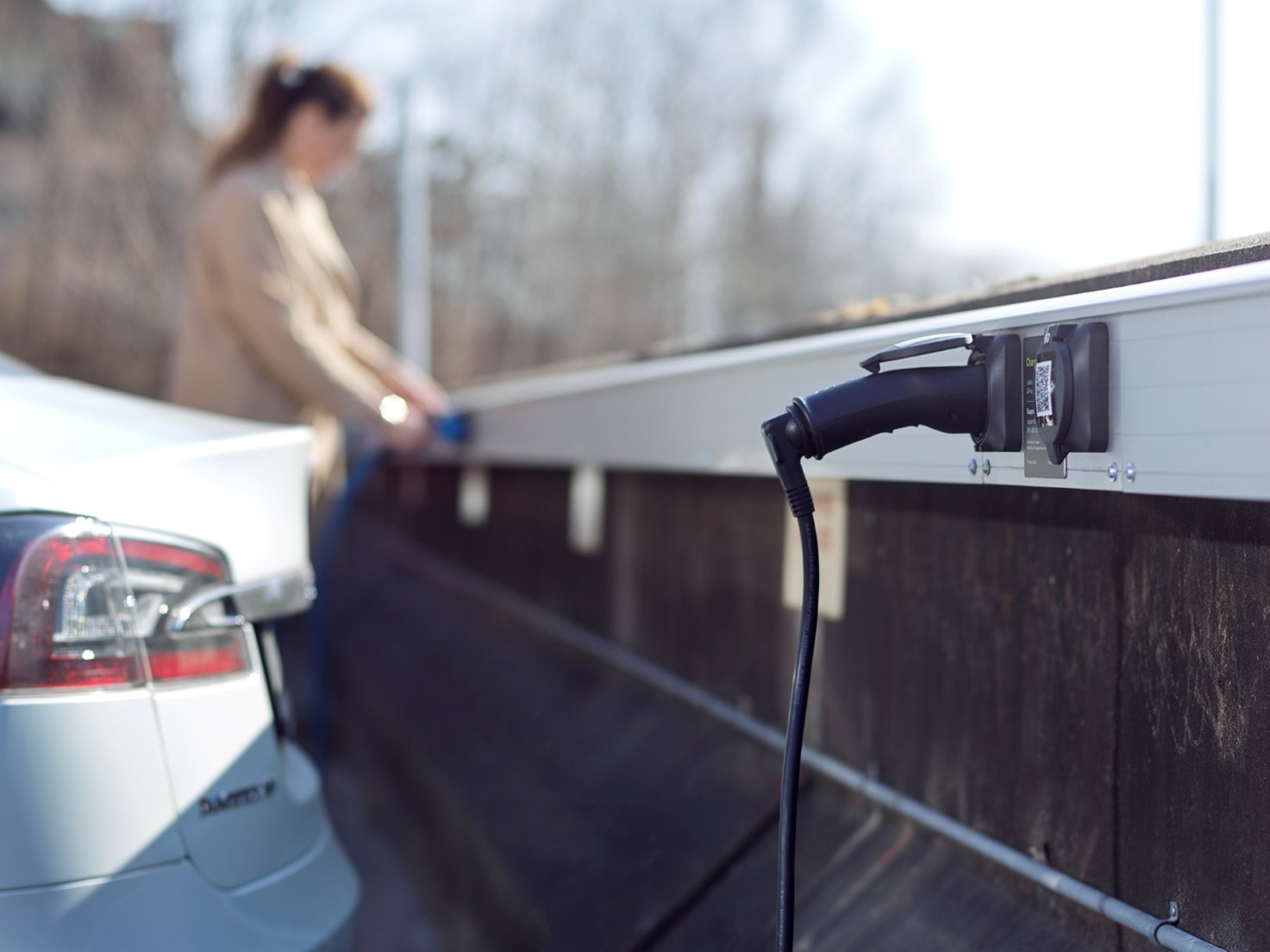 a person standing next to a car